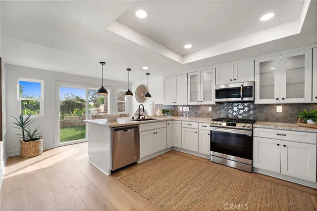 a kitchen with stove a sink and appliances