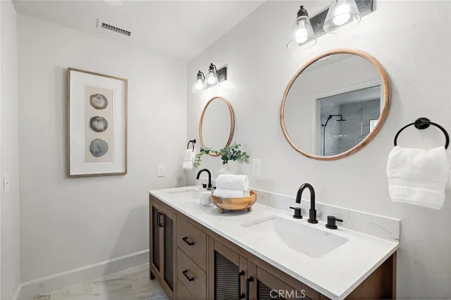 a bathroom with a double vanity sink and a mirror