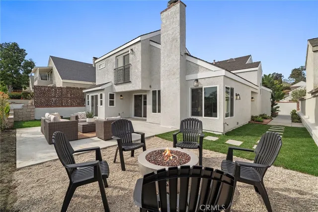 a view of a patio with table and chairs with wooden floor and fence