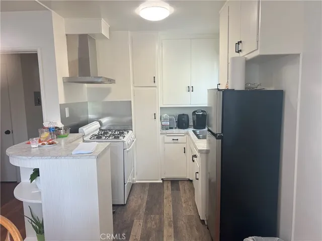 a kitchen with a refrigerator and a stove