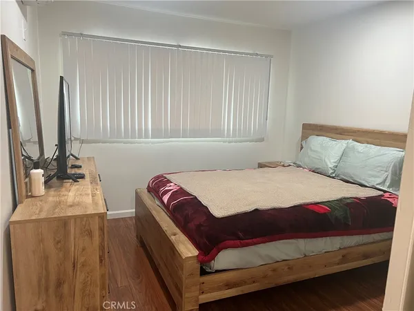 a bedroom with a bed next to a large window