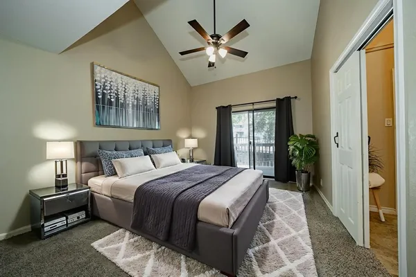 a bedroom with a large bed and a chandelier