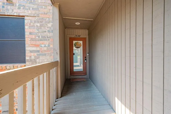 a view of a balcony with wooden floor
