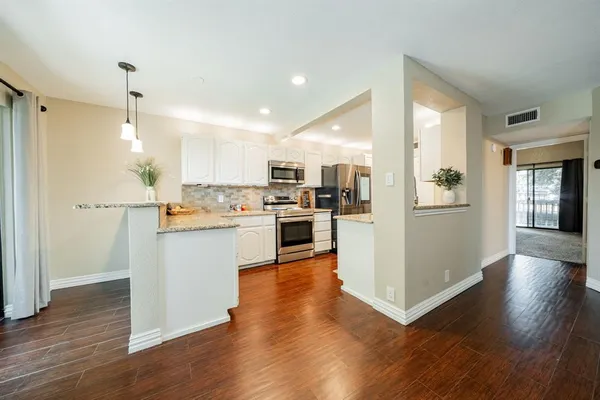 a view of kitchen with wooden floor