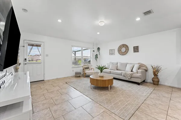 a living room with furniture and a flat screen tv