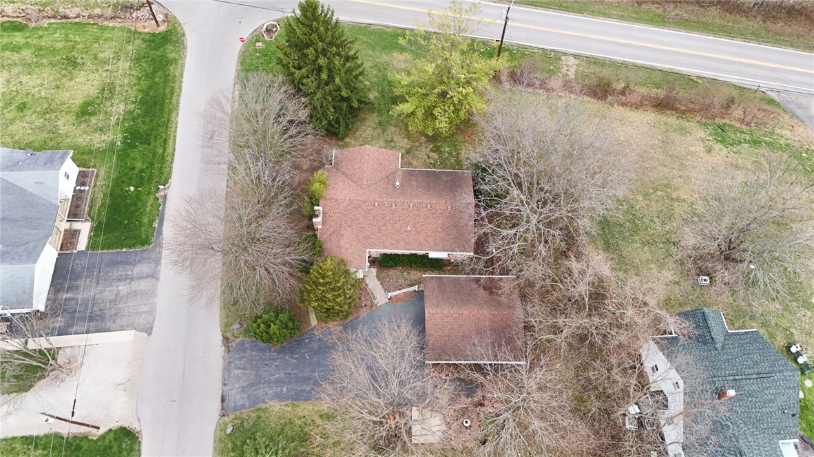 6711 Hamilton-Middletown Road Franklin, OH 45005 - Photo 48 of 49 This aerial view showcases a residential property nestled amongst mature trees and lush greenery.