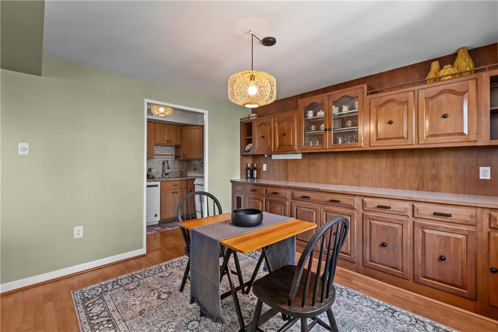 4625 Fifth Avenue, Unit 206 Pittsburgh, PA 15213 - Photo 13 of 31 a view of a dining room with furniture wooden floor and chandelier