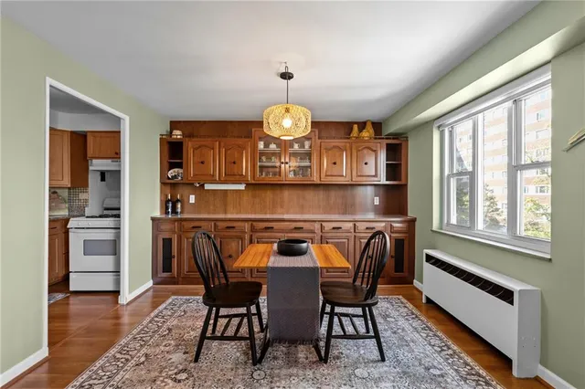 a dining room with furniture and wooden floor