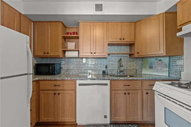a kitchen with stainless steel appliances granite countertop a stove and a sink