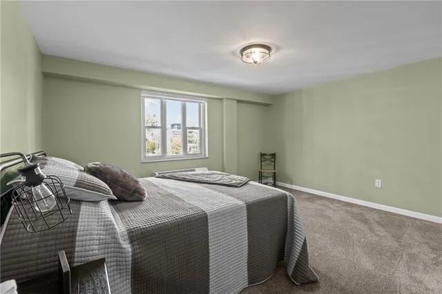 a bedroom with a bed and a table