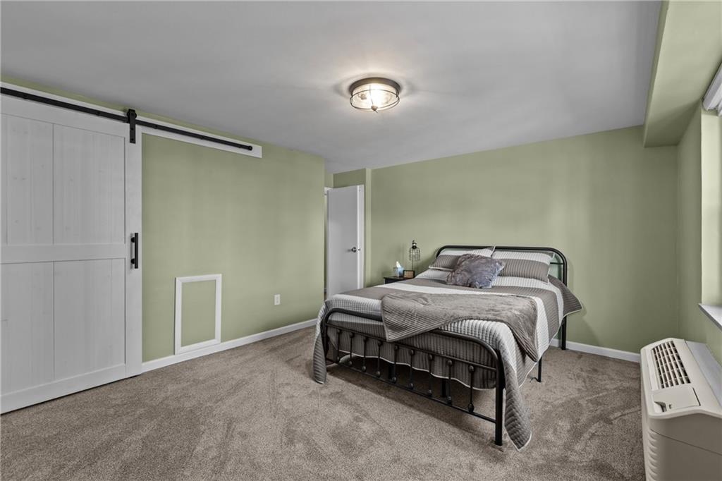 4625 Fifth Avenue, Unit 206 Pittsburgh, PA 15213 - Photo 24 of 31 a bedroom with a bed and a table