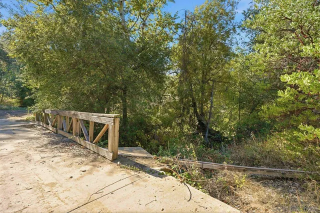 a view of a park with iron fence