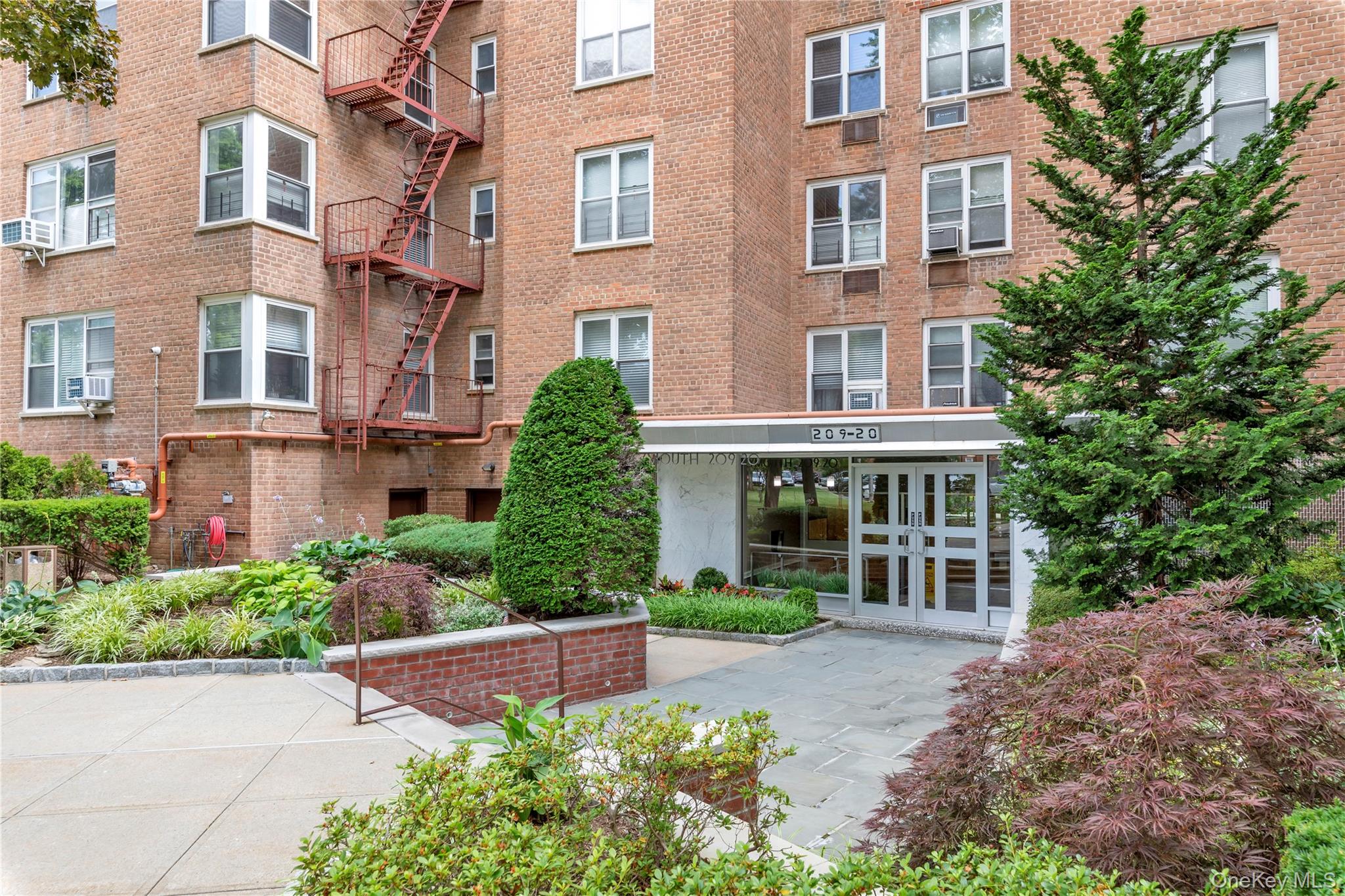 209-20 18th Avenue, Unit 6C Queens, NY 11360 - Photo 13 of 14 front view of a brick building