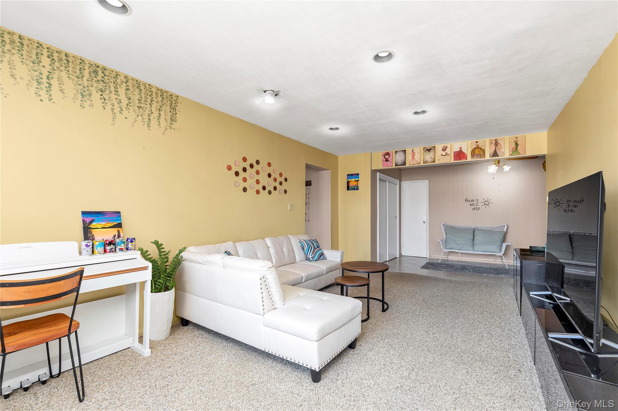 209-20 18th Avenue, Unit 6C Queens, NY 11360 - Photo 4 of 14 a bedroom with furniture and a flat screen tv