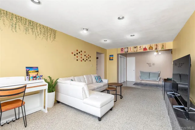 a bedroom with furniture and a flat screen tv