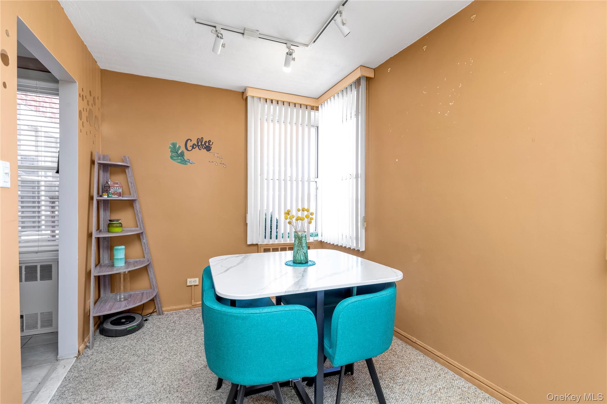 209-20 18th Avenue, Unit 6C Queens, NY 11360 - Photo 7 of 14 a room with furniture and a window