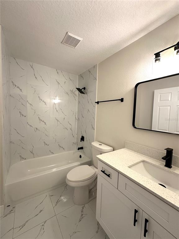1758 Clarcona Road Apopka, FL 32703 - Photo 14 of 20 a bathroom with a sink a toilet and a mirror