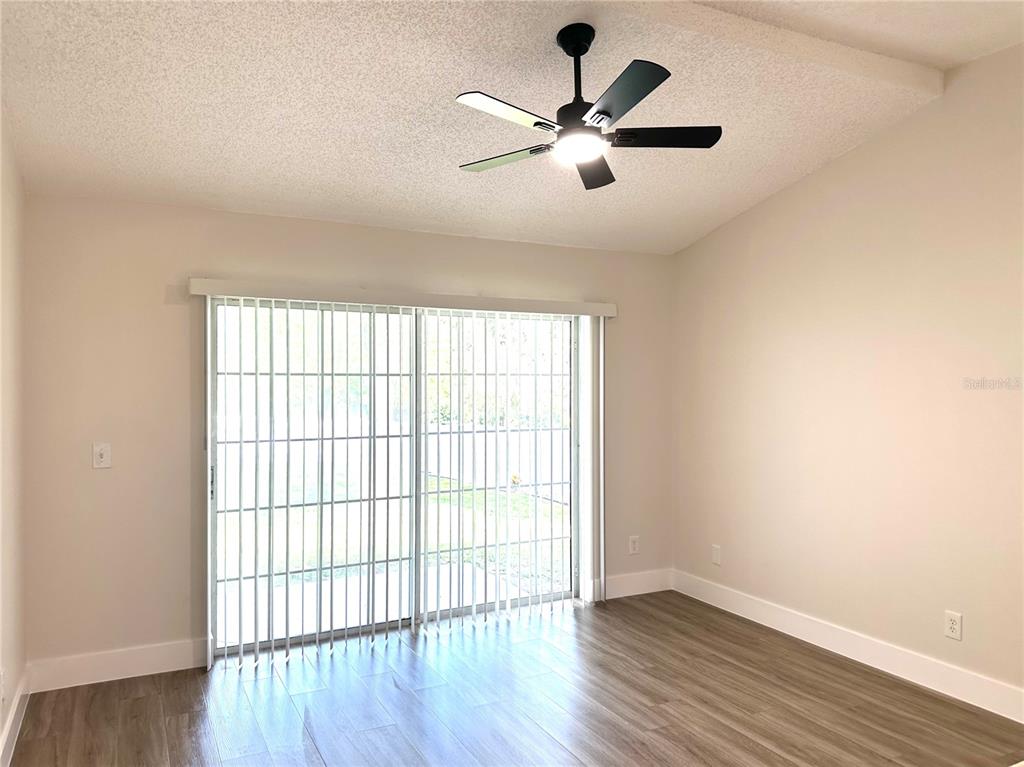 1758 Clarcona Road Apopka, FL 32703 - Photo 8 of 20 an empty room with wooden floor and windows