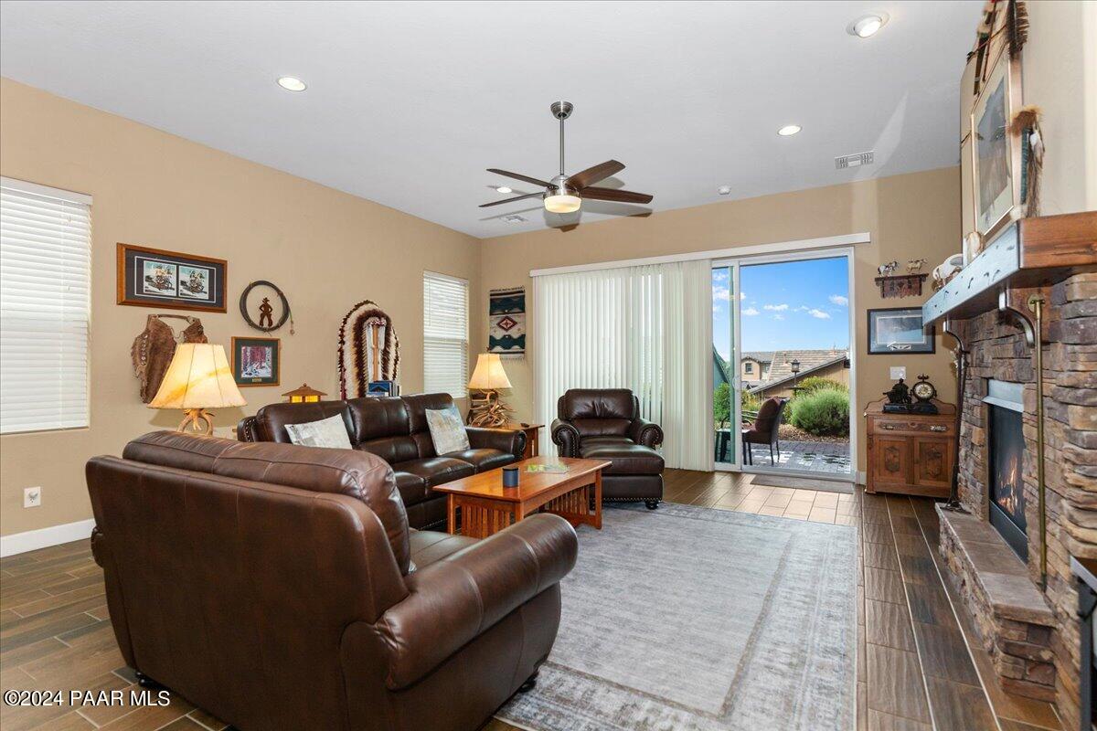 2206 Calgary Drive Prescott, AZ 86301 - Photo 9 of 54 a living room with furniture a fireplace and a chandelier