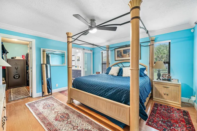 a bedroom with a bed window and walk in closet