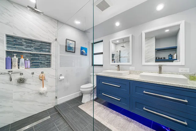 a spacious bathroom with a granite countertop sink mirror and toilet