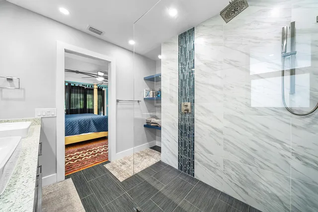 a bathroom with a glass shower door and a toilet