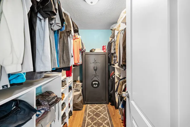 a view of walk in closet with clothes and shoes