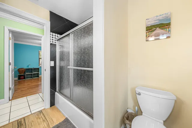 a bathroom with a toilet and a shower