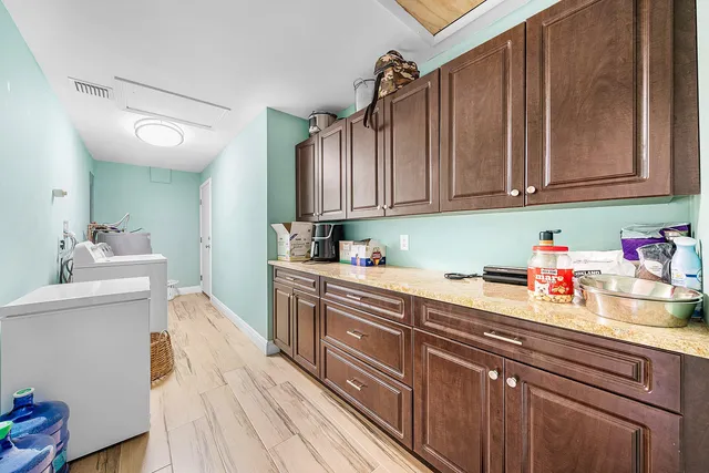 a kitchen with granite countertop a sink dishwasher stove and cabinets