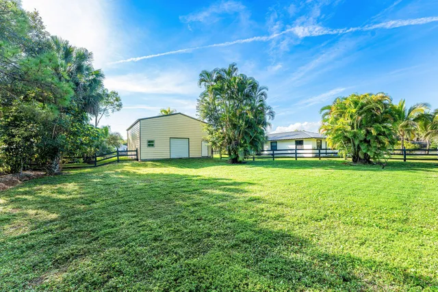 a swimming pool with trees in the background