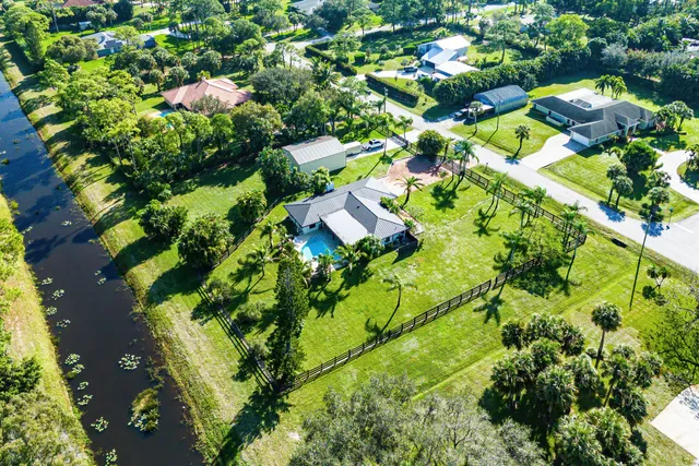 an aerial view of a house with a yard basket ball court and outdoor seating