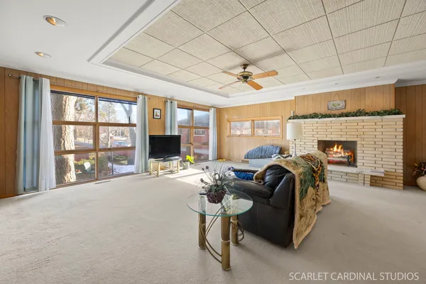 a living room with furniture a flat screen tv and a fireplace