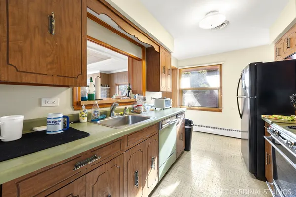 a kitchen with sink and refrigerator