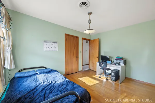 a bedroom with a bed and a chandelier