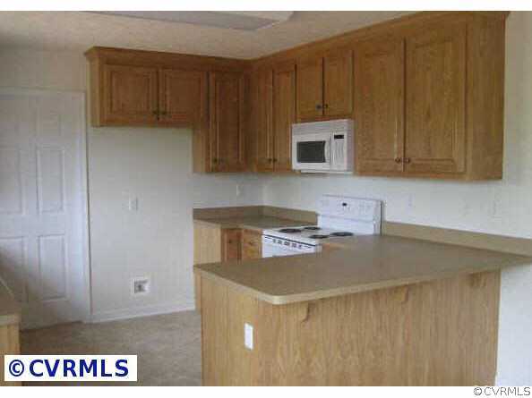 2225 Turkey Island Road Crewe, VA 23930 - Photo 3 of 6 a kitchen with kitchen island a stove a sink and a microwave
