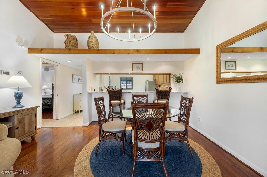16650 Partridge Place Road, Unit 204 Fort Myers, FL 33908 - Photo 12 of 47 a view of a dining room with furniture and wooden floor