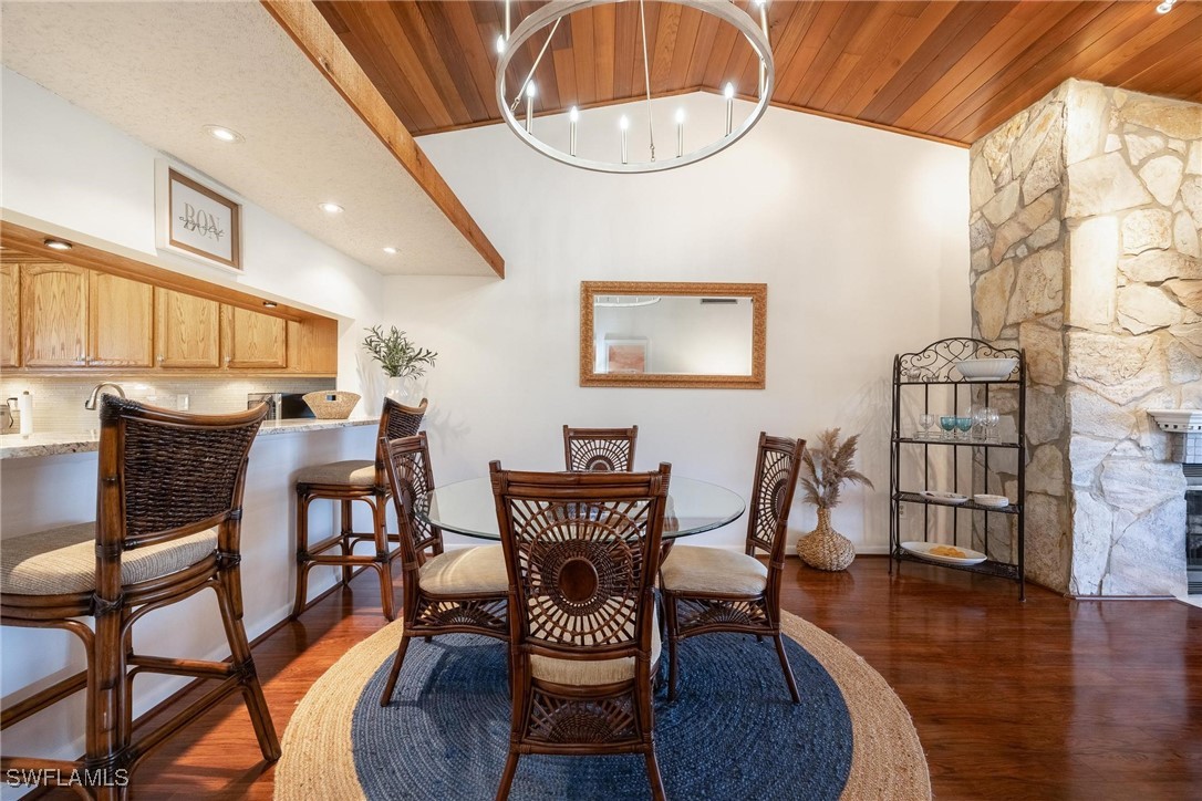 16650 Partridge Place Road, Unit 204 Fort Myers, FL 33908 - Photo 13 of 47 a view of a dining room with furniture and wooden floor