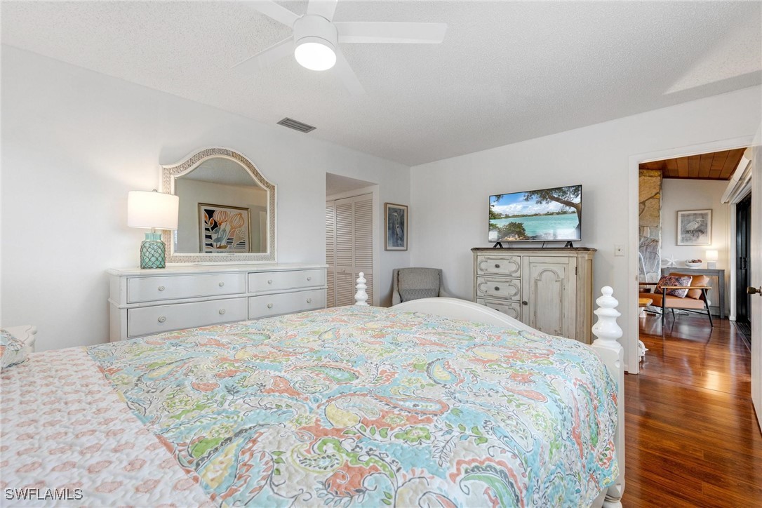 16650 Partridge Place Road, Unit 204 Fort Myers, FL 33908 - Photo 21 of 47 a bedroom with a large bed and a chandelier