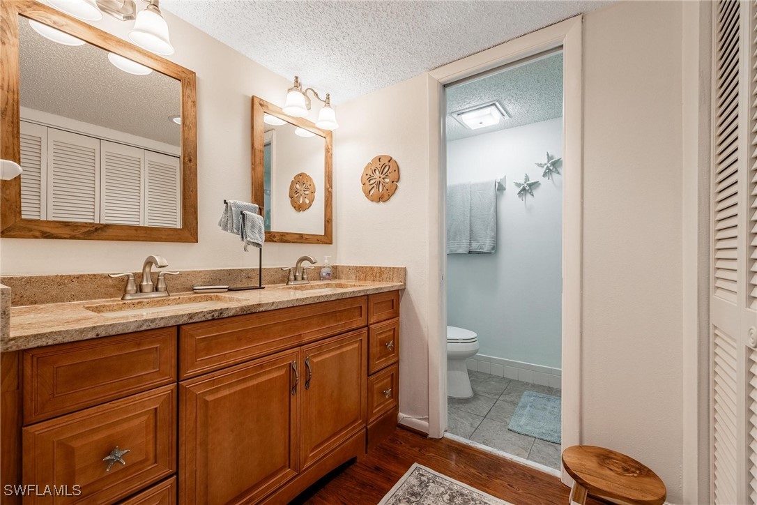 16650 Partridge Place Road, Unit 204 Fort Myers, FL 33908 - Photo 22 of 47 a bathroom with a granite countertop sink toilet and mirror