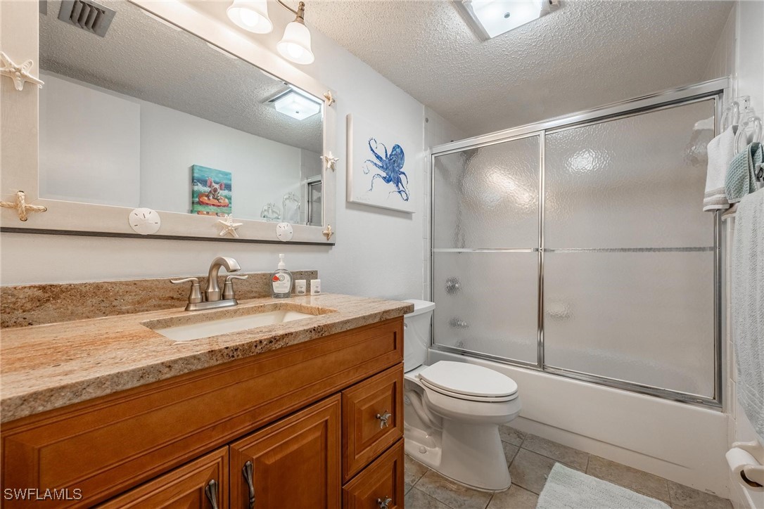16650 Partridge Place Road, Unit 204 Fort Myers, FL 33908 - Photo 26 of 47 a bathroom with a granite countertop sink toilet and shower