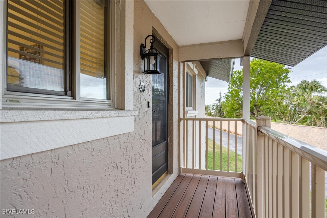 16650 Partridge Place Road, Unit 204 Fort Myers, FL 33908 - Photo 6 of 47 a view of a balcony with wooden floor