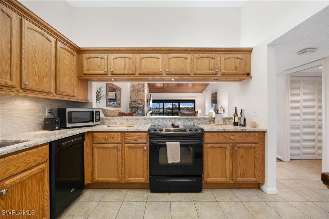 16650 Partridge Place Road, Unit 204 Fort Myers, FL 33908 - Photo 8 of 47 a kitchen with stainless steel appliances granite countertop a stove and a sink