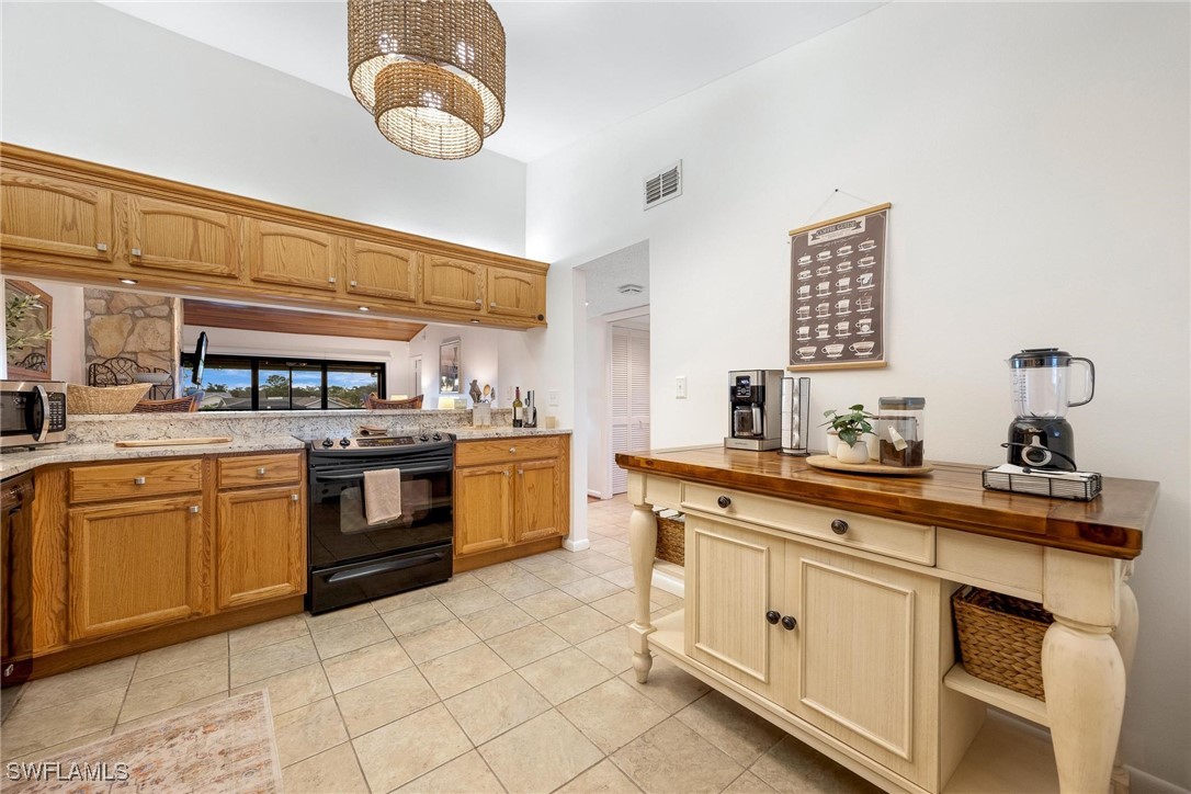 16650 Partridge Place Road, Unit 204 Fort Myers, FL 33908 - Photo 9 of 47 a kitchen with cabinets and appliances