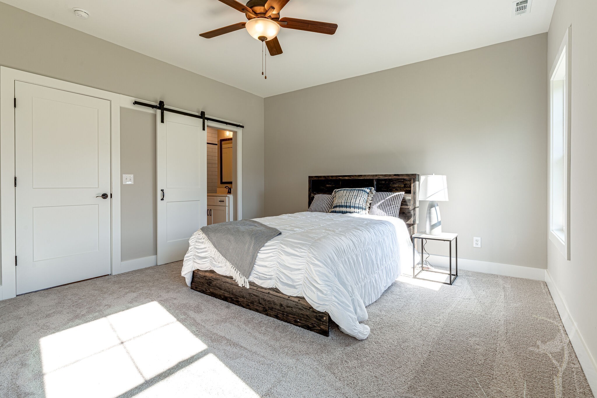 1024 Sycamore Ridge West, Unit 43 Burns, TN 37029 - Photo 42 of 59 a spacious bedroom with a bed and a chandelier