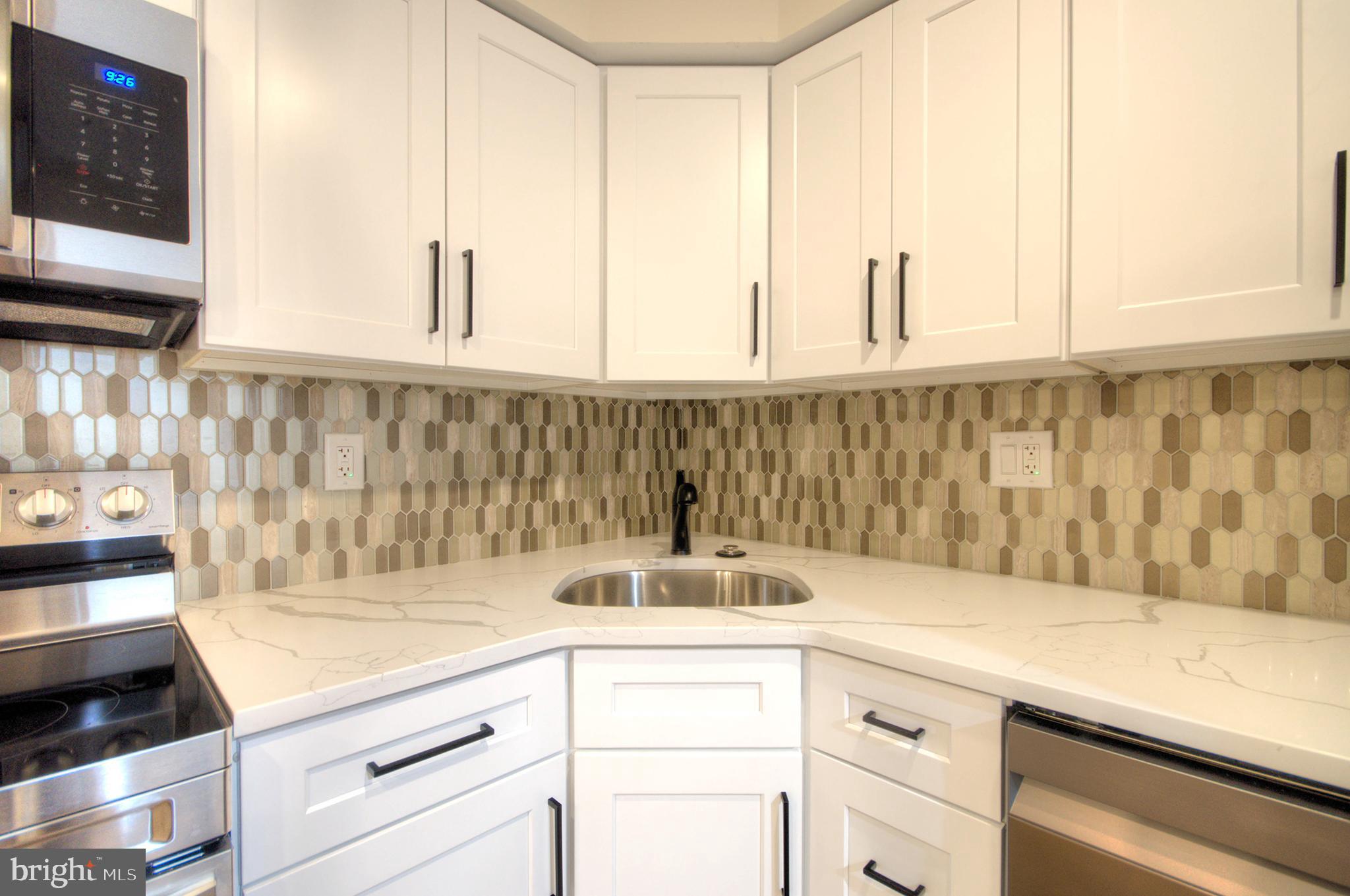 14 Pickwick Place Sewell, NJ 08080 - Photo 21 of 36 a kitchen with a sink and cabinets