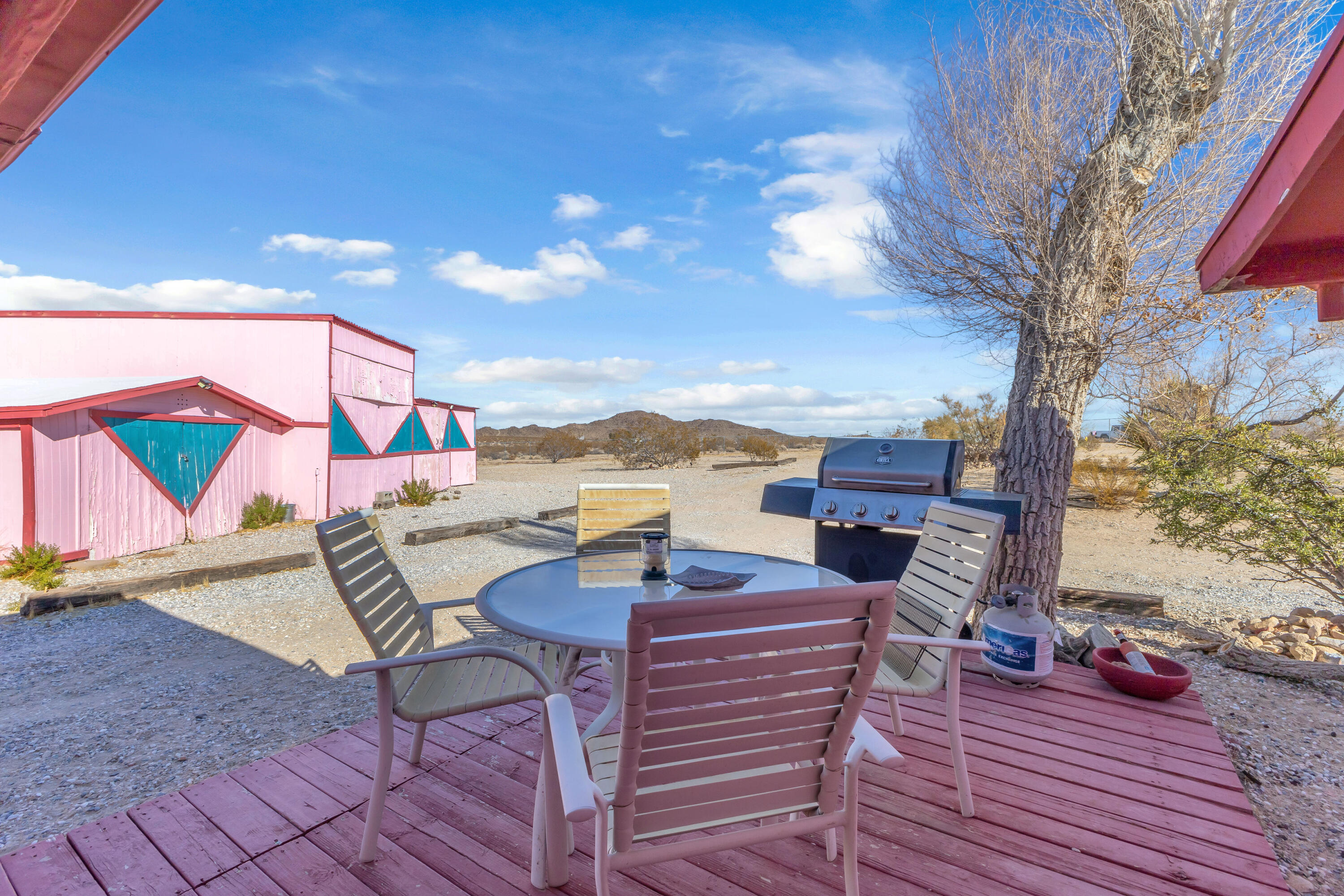 2642 Star Lane Joshua Tree, CA 92252 - Photo 2 of 76 a view of a rooftop deck with couch and chairs