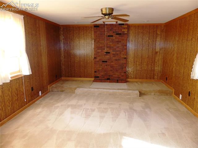 660 Loflin Road Colorado Springs, CO 80930 - Photo 5 of 11 Master bedroom. Wood stove backwall and hearth