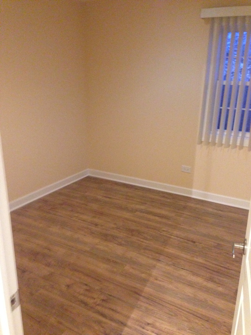 672 Cleo Court Wheeling, IL 60090 - Photo 15 of 20 a view of an empty room with wooden floor