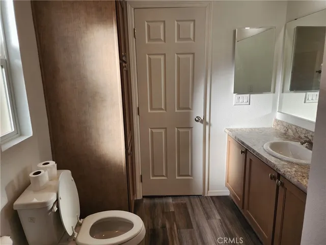 a bathroom with a sink a toilet and mirror