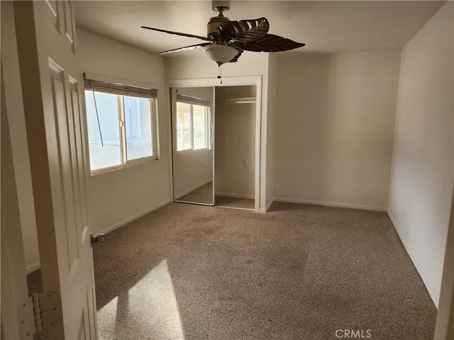 a view of a big room with closet and windows